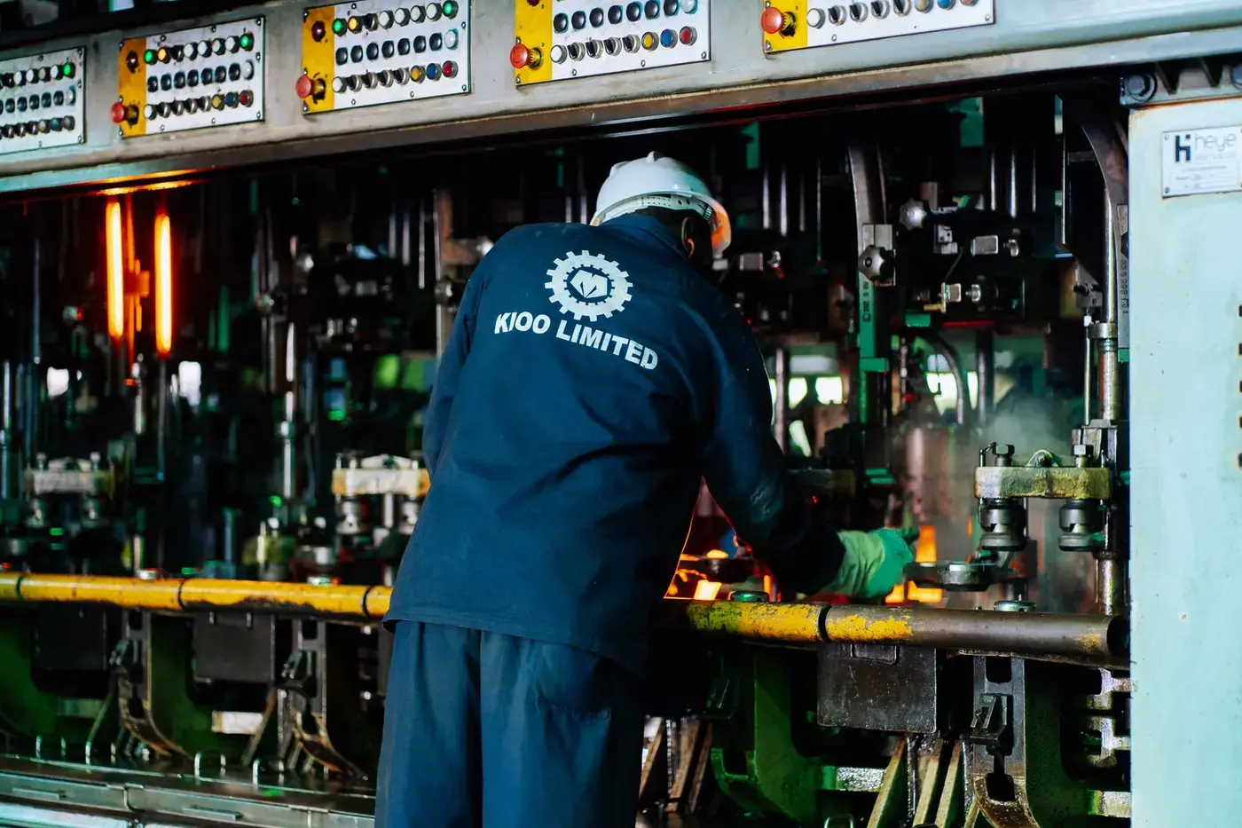 Plant operator supervising process machinery on an industrial floor
